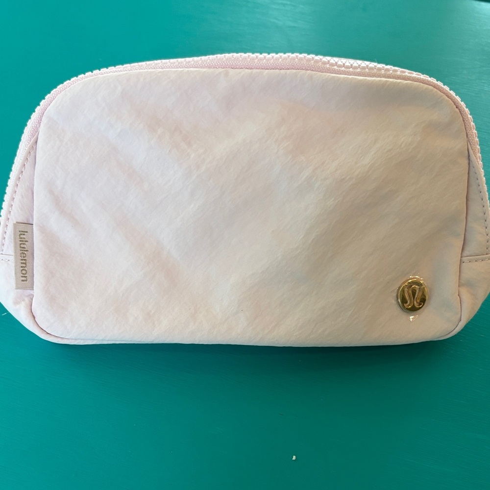 lululemon athletica light pink cosmetic pouch with gold logo